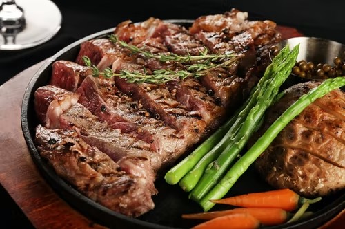 Plate of rib eye steak with vegetables